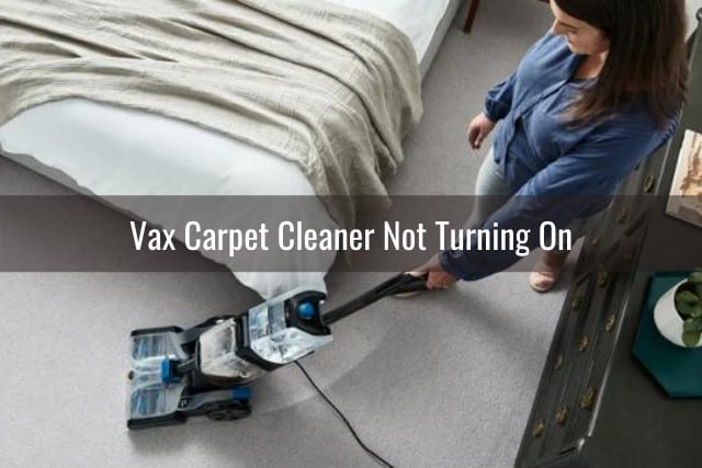 Woman cleaning the carpet using Vax