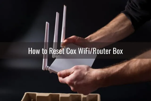 Man holding a white wifi router