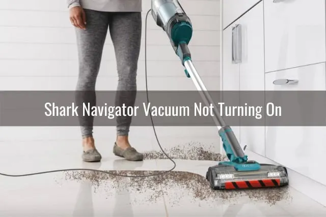 Woman cleaning the carpet using vacuum