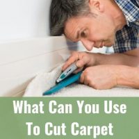 Handyman cutting carpet with knife