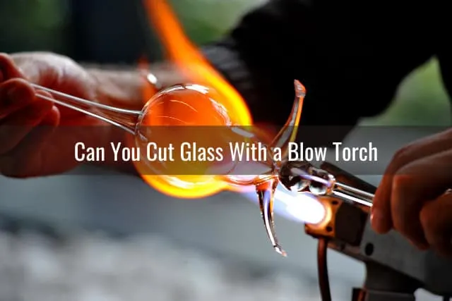 Man cutting the glass using blow torch