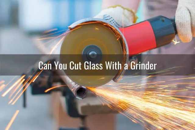 Man cutting the glass using grinder