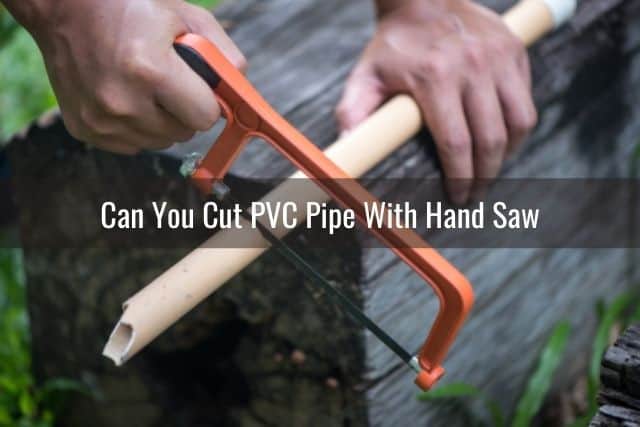 Hand saw cutting PVC pipe
