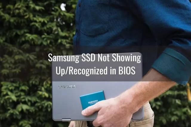 Man holding Laptop and SSD