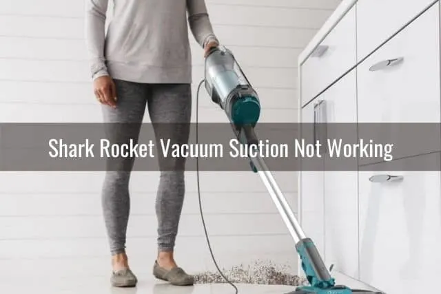 Vacuuming dirt off kitchen floor