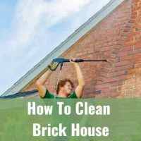 Man cleaning the brick house using washing tool
