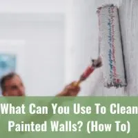 Man painting the wall using roll brush