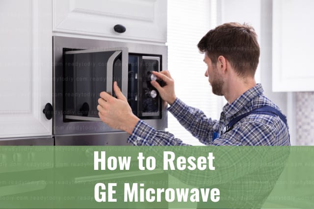 Man adjusting the button of the microwave