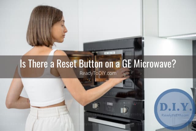 Woman adjusting the button of the microwave