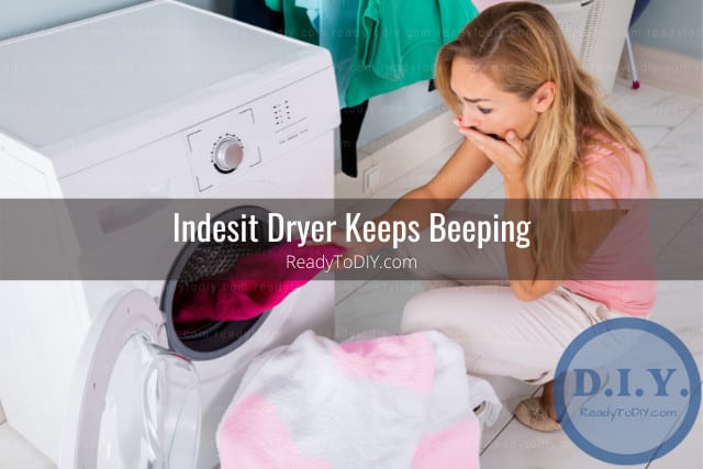 Woman looking at the clothes beside the dryer