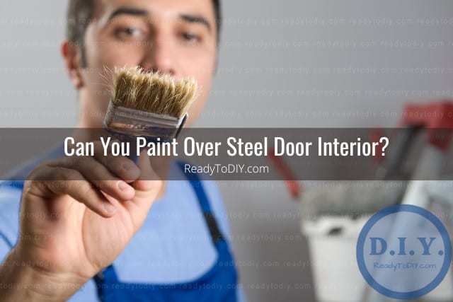 Painting the steel door using paint brush