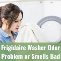 Woman smelling the clothes from the washer