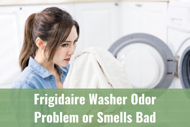 Woman smelling the clothes from the washer