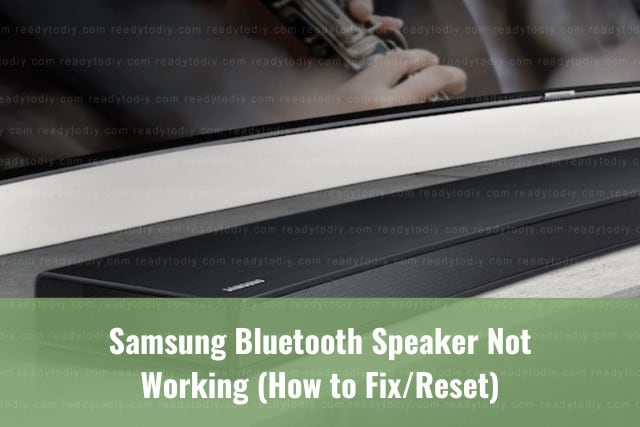 Black modern speaker below the flatscreen tv