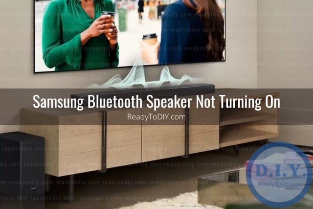 Black modern speaker below the flatscreen tv