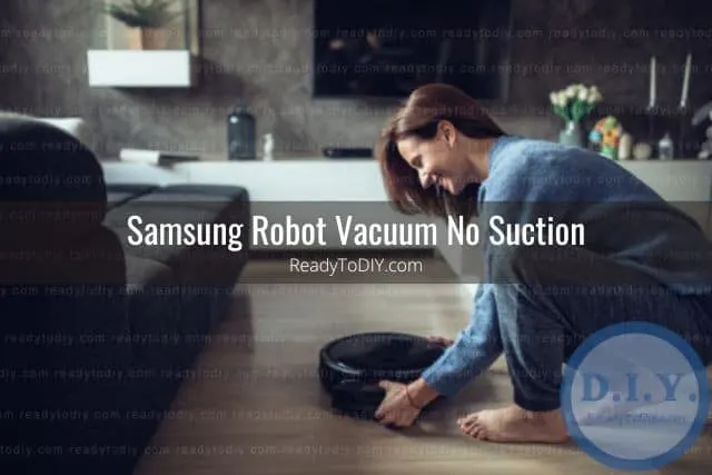 Woman turning on robot vacuum