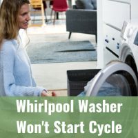 Modern white washer with clothes inside