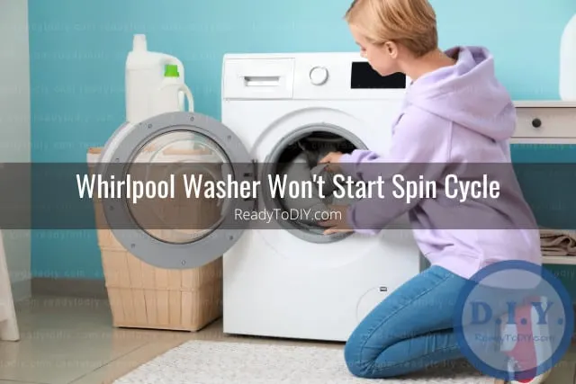 Modern white washer with clothes inside