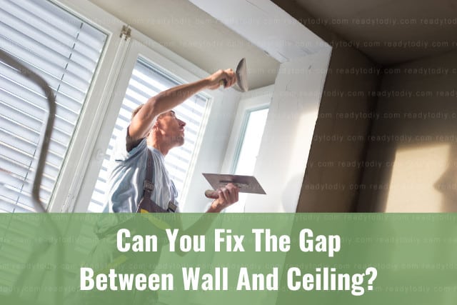 Man fixing the wall and ceiling using cement
