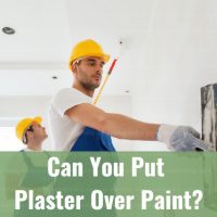 Two man painting and putting plaster on the wall