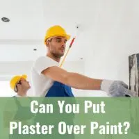 Two man painting and putting plaster on the wall