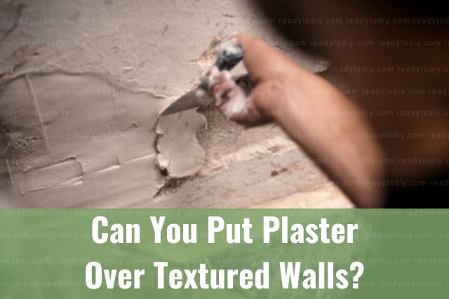 Man putting plaster on the wall
