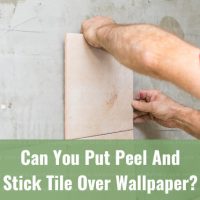 man installing tiles at the wall