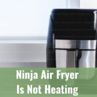 Modern air fryer in the kitchen with food inside
