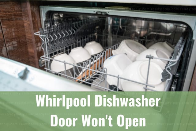 White dishwasher in the kitchen with plates inside