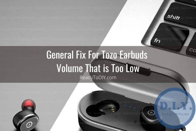 Tozo earbuds and case sitting by laptop